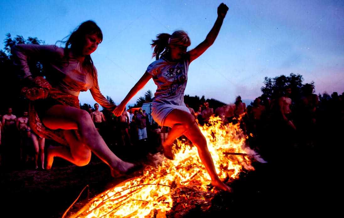 omsk region russia 9th july 2017 girls jump over a bonfire during JGNRBM